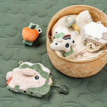 Load image into Gallery viewer, A collection of Done by Deer toys with a basket on a green textured surface.
