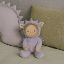 Load image into Gallery viewer, Stuffed toy in a purple costume with animal ears and tail on a soft surface with pillows.