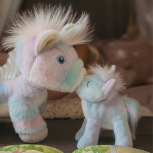 Load image into Gallery viewer, Two plush unicorn toys interacting on a surface with a blurred background