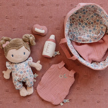Load image into Gallery viewer, Baby doll and accessories on a pink textured surface