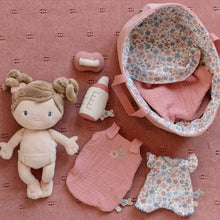 Load image into Gallery viewer, Baby doll and clothing set on a pink textured surface with a floral-patterned basket.