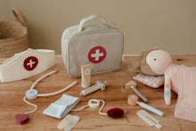 Load image into Gallery viewer, Children's medical playset with toy doctor's bag, stethoscope, and plush monkey on a wooden surface.