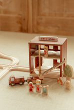 Load image into Gallery viewer, Little Dutch Wooden toy fire station with miniature figures and a fire truck on a wooden floor.