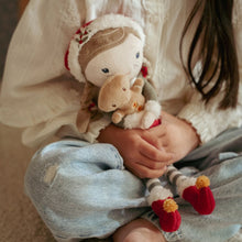 Load image into Gallery viewer, Child holding a plush toy little dutch Rosa with a Christmas gingerbread man