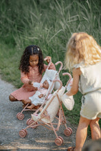 Load image into Gallery viewer, Two children playing with a pink doll stroller outdoors.