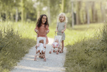 Load image into Gallery viewer, Two young girls pushing baby buggies in a forest setting