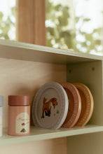 Load image into Gallery viewer, Set of children's plates with a lion design on a shelf.