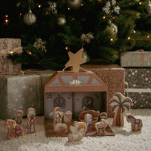 Load image into Gallery viewer, Wooden nativity scene with a star on top, surrounded by Christmas decorations and presents.