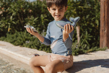 Load image into Gallery viewer, Child playing with Little dutch Ocean World Dive Figures Set of three ocean-themed weighted learn to swim aids: a whale, a starfish, and a fish