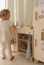 Load image into Gallery viewer, Child playing with a wooden dishwasher kitchen set in a room with light-colored walls.