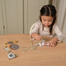 Load image into Gallery viewer, A set of lacing cards featuring farm animals and a tractor with a barn, including cards and string for lacing.
