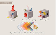 Load image into Gallery viewer, Toy packaging with various compartments and toys on a beige background

