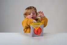 Load image into Gallery viewer, Child playing with a toy box on a plain background
