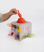Load image into Gallery viewer, Colorful baby toy cube with a hand interacting with it on a white background
