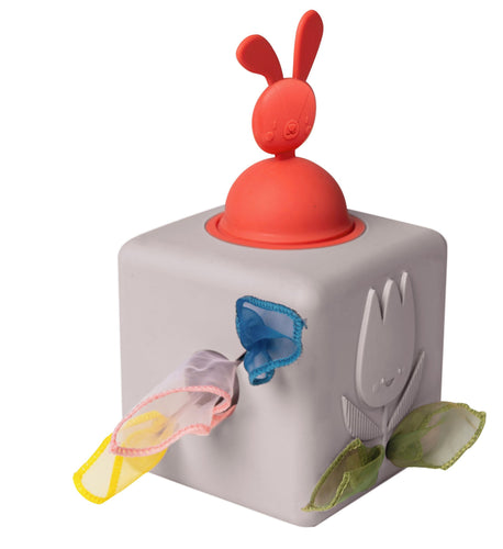 Toy block with a red bunny top and various colorful parts on a white background