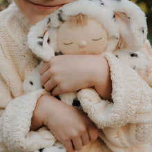 Load image into Gallery viewer, Child holding a soft toy wrapped in a knitted blanket
