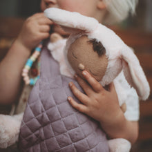 Load image into Gallery viewer, Child holding a plush toy in a lavender baby carrier
