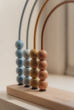 Load image into Gallery viewer, Colorful abacus with wooden base on a neutral background

