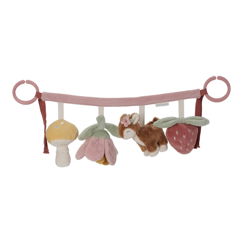 A stroller toy chain featuring plush toys including a mushroom, a deer, a flower, and a strawberry, attached to a pink strap.