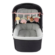 Load image into Gallery viewer, Cot with the stroller toy chain featuring plush toys including a mushroom, a deer, a flower, and a strawberry, attached to a pink strap.
