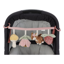 Load image into Gallery viewer, The stroller toy chain featuring plush toys including a mushroom, a deer, a flower, and a strawberry, attached to a pink strap.
