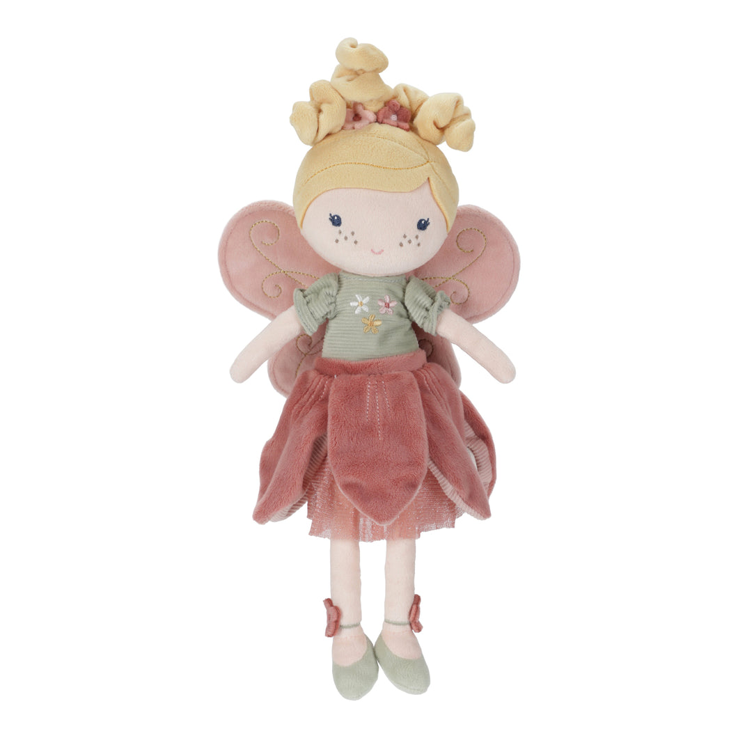 Stuffed toy fairy with pink wings and a dress on a white background