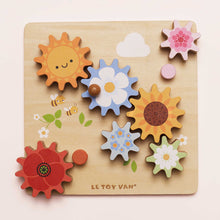 Load image into Gallery viewer, Wooden puzzle with colorful flowers and sun shapes on a light pink background, featuring the brand &#39;Le Toy Van&#39;.
