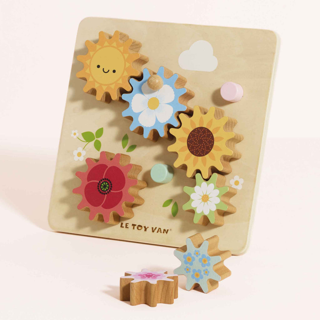 Wooden puzzle with colorful floral shapes on a beige background, featuring the Le Toy Van brand.