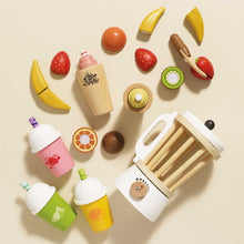 Load image into Gallery viewer, Wooden toy food items including fruits, a bottle, and a juicer on a beige background
