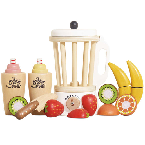 Wooden toy kitchen set with fruits and a blender on a white background