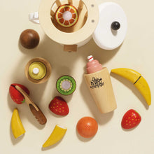 Load image into Gallery viewer, Collection of wooden toy fruits and a juicer on a beige background
