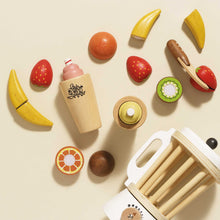 Load image into Gallery viewer, Wooden toy fruits and kitchen items on a beige background
