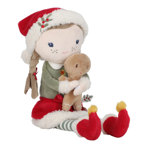 Plush toy Little dutch Rosa in Christmas attire holding a gingerbread man on a white background