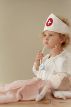 Load image into Gallery viewer, Child in a nurse's outfit with a stethoscope and headband,
