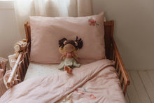 Load image into Gallery viewer, Children&#39;s bed with pink bedding and a doll, in a softly lit room.
