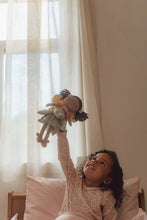Load image into Gallery viewer, Child playing with a toy fairy Evi in a bedroom with light curtains.
