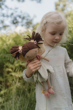 Load image into Gallery viewer, Young girl holding a Little Dutch Fairy Garden Evi toy fairy doll with braided hair in a natural setting
