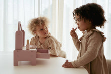 Load image into Gallery viewer, Two children playing with a little dutch pink vanity dressing table
