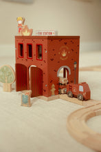 Load image into Gallery viewer, Wooden toy fire station with a fire truck and accessories on a neutral background

