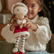 Load image into Gallery viewer, Child holding a plush toy little dutch Rosa with a Christmas theme
