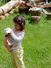 Load image into Gallery viewer, Child holding a olli ella doll in a rose pink carrier
