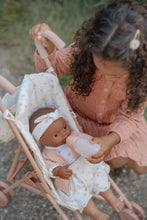 Load image into Gallery viewer, Child playing with a doll in a stroller outdoors
