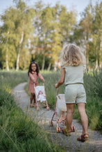 Load image into Gallery viewer, Two children walking along a path in a natural setting with trees and grass.
