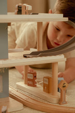 Load image into Gallery viewer, Child playing with a wooden toy train set
