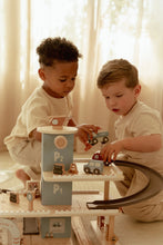 Load image into Gallery viewer, Two children playing with a toy train set 
