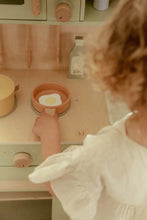 Load image into Gallery viewer, Child playing with a toy kitchen set, focusing on a pink pot.
