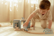 Load image into Gallery viewer, Child playing with a toy train set 
