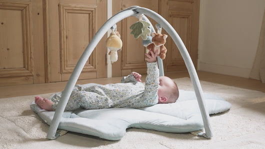 Baby playing with Forest Friends Activity Playmat Gym
