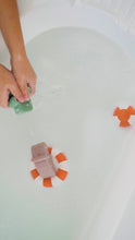 Load and play video in Gallery viewer, Child playing with the Done by deer Bath Squirter Toy Croco - Green bath toy which squirts water 
