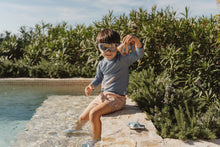 Load image into Gallery viewer, Child playing with Little dutch Ocean World Dive Figures Set of three ocean-themed weighted learn to swim aids: a whale, a starfish, and a fish
